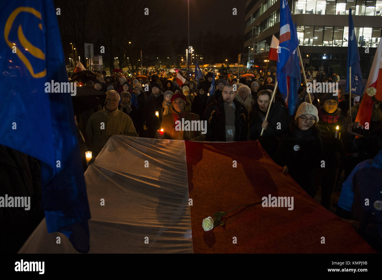 Krakow, Poland. 8th Dec, 2017. People gather in front of Krakow Court while holding a large polish flag to protest against the new judicial reforms. Today, The Polish parliament approved the government proposals to hand the ruling Law and Justice party (PiS) total control of judicial appointments and the supreme court. Credit: Omar Marques/SOPA/ZUMA Wire/Alamy Live News Stock Photo