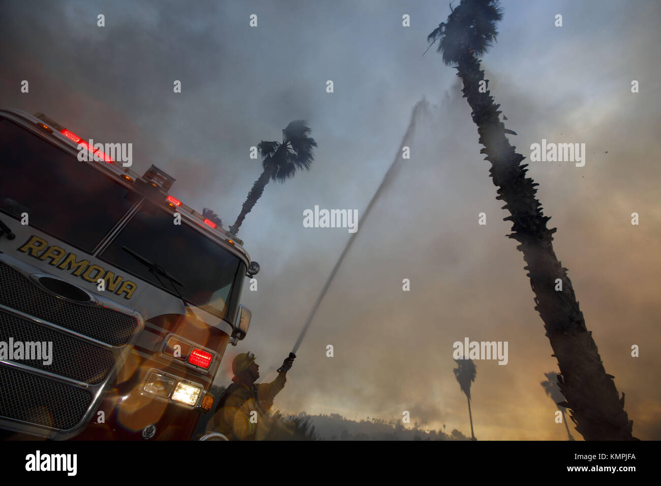 Bonsall, CA, USA. 7th Dec, 2017. Firefighters spray water on burning ...