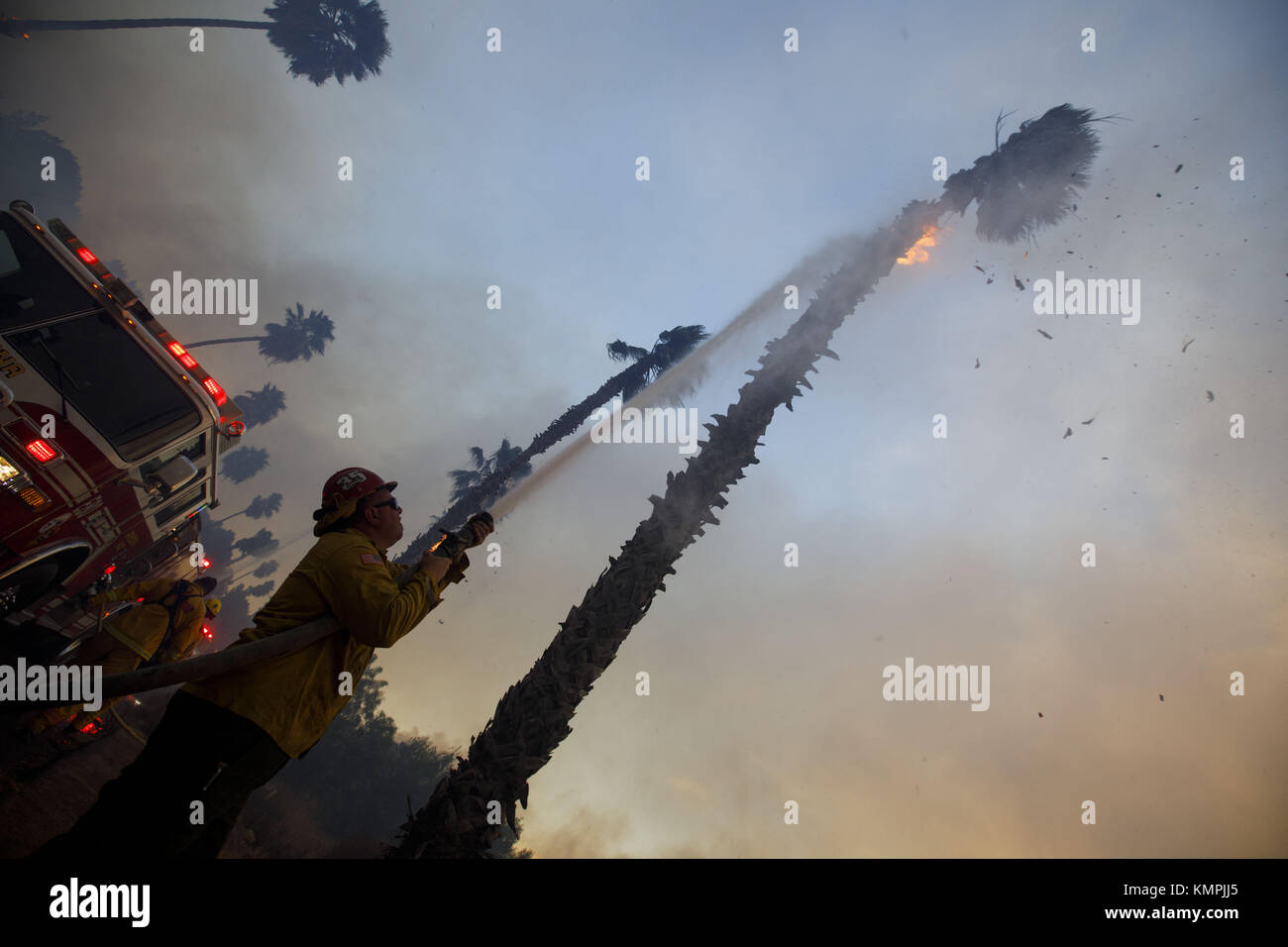 Bonsall, CA, USA. 7th Dec, 2017. Firefighters spray water on burning ...