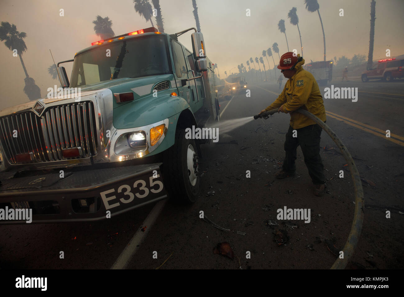 Bonsall, CA, USA. 7th Dec, 2017. A USFS firefighter extinguishes a ...