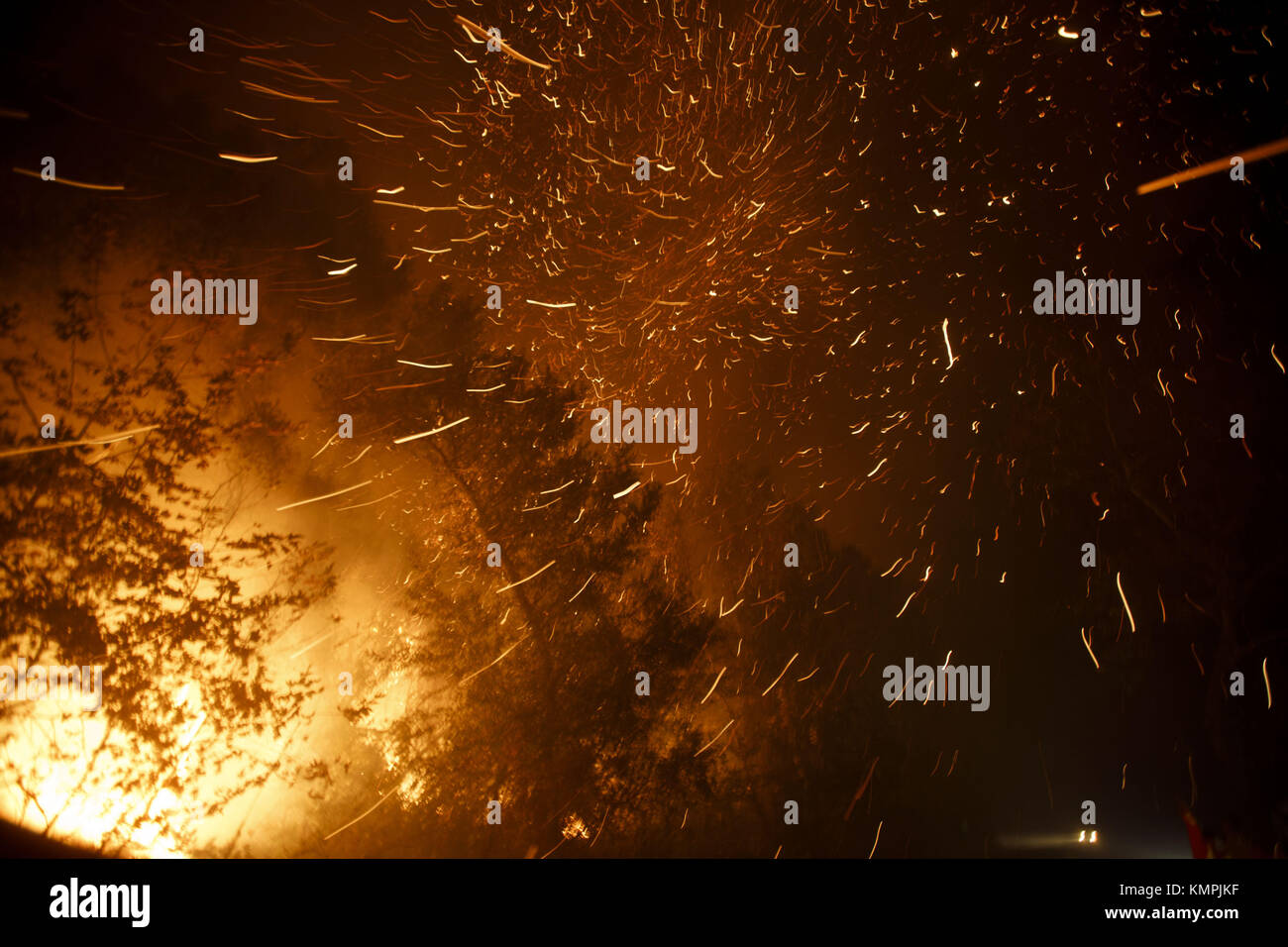 Bonsall, CA, USA. 7th Dec, 2017. Burning trees on Olive Hill Road throw