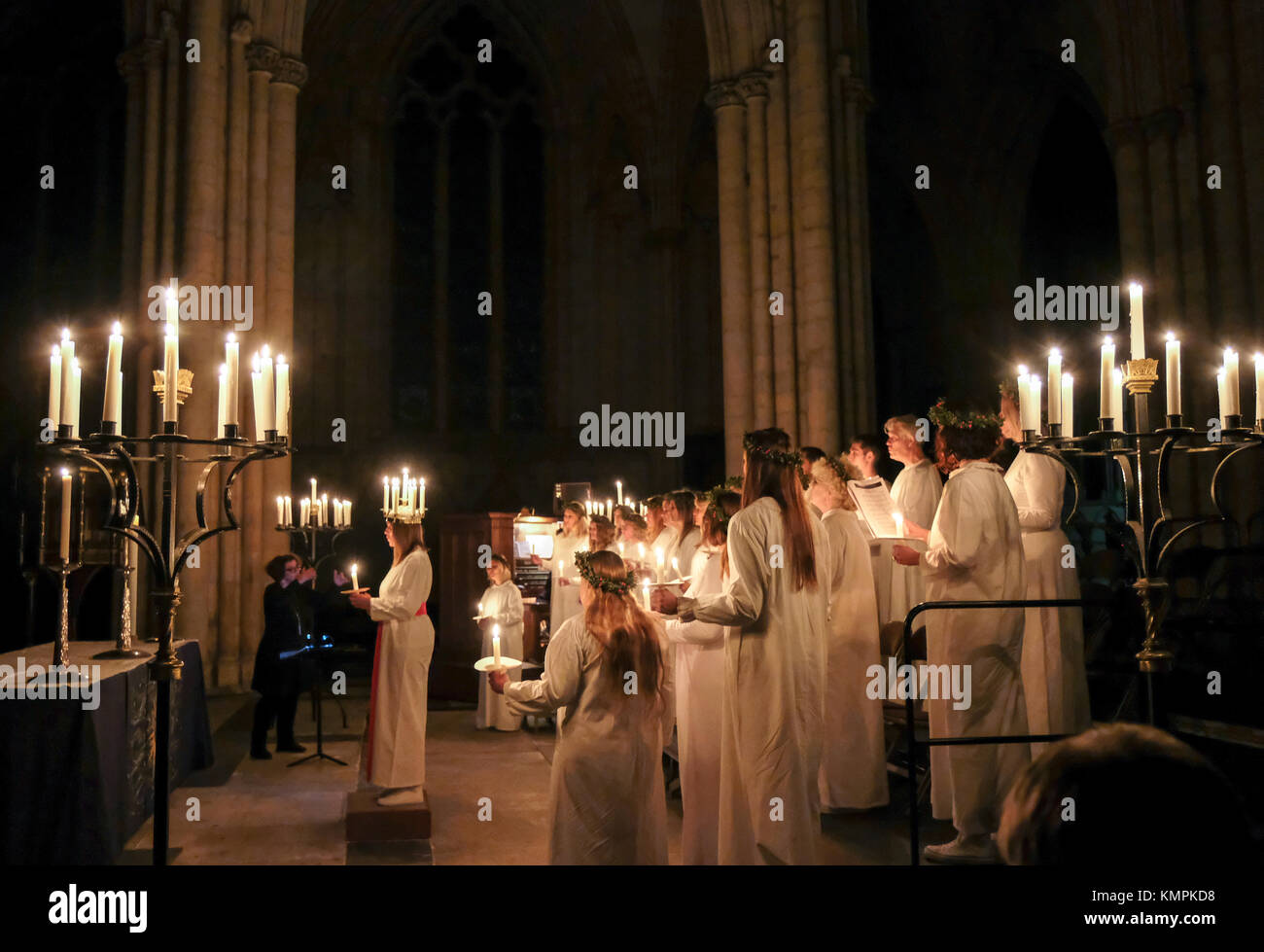 York, UK. 8th December, 2017. Linnea Hennersten from Uppsala, Sweden, together with the London Nordic Choir, performs the role of Lucia in this year's candlelit Sankta Lucia festival at York Minster. Credit - Alternative Occasions Photography/Alamy Live News Stock Photo