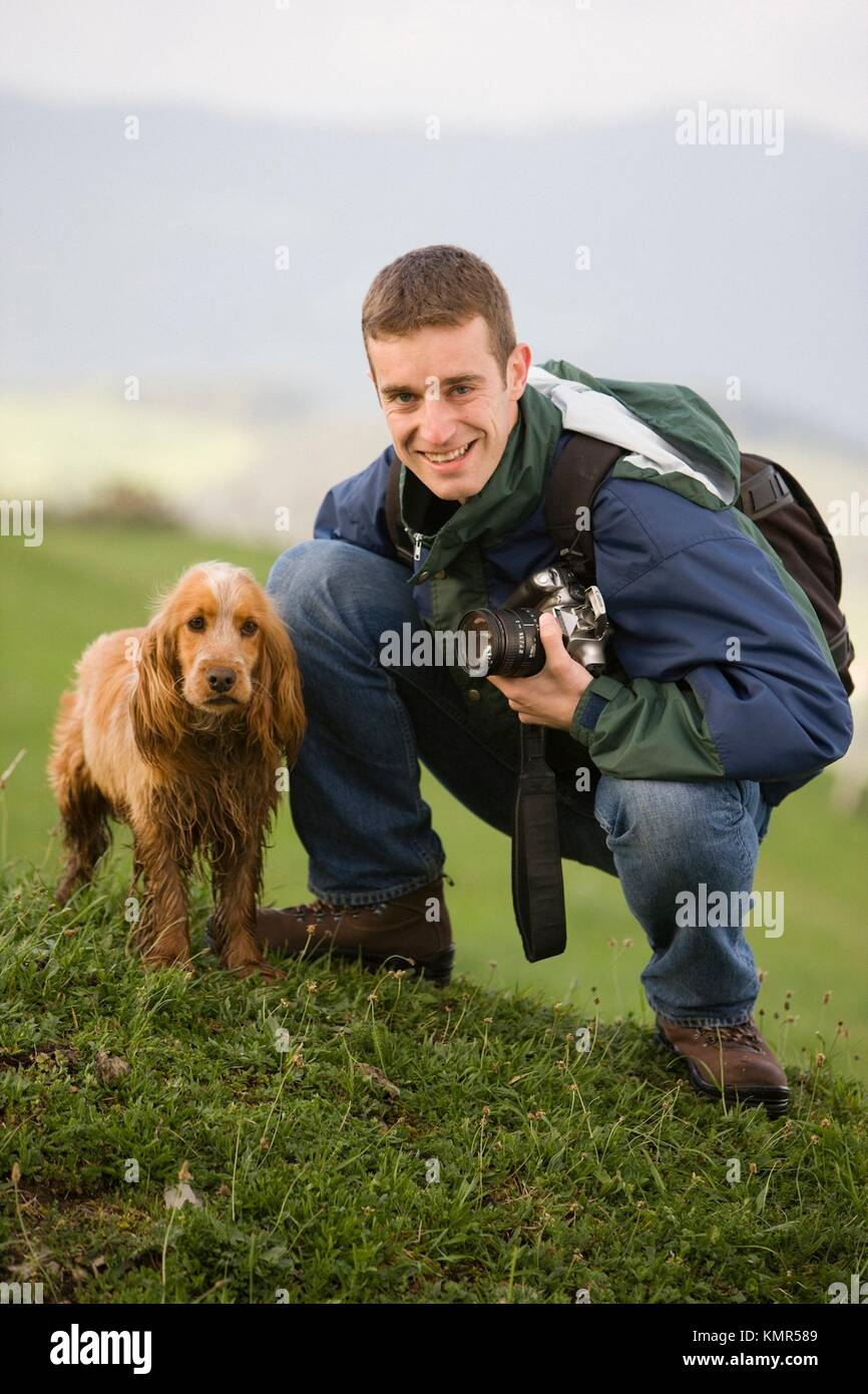 Man in the mountains with dog and camera, Gipuzkoa, Basque Country, Spain Stock Photo