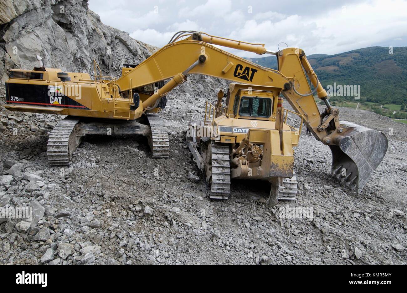 Extracting raw material from quarry for cement manufacturing Stock