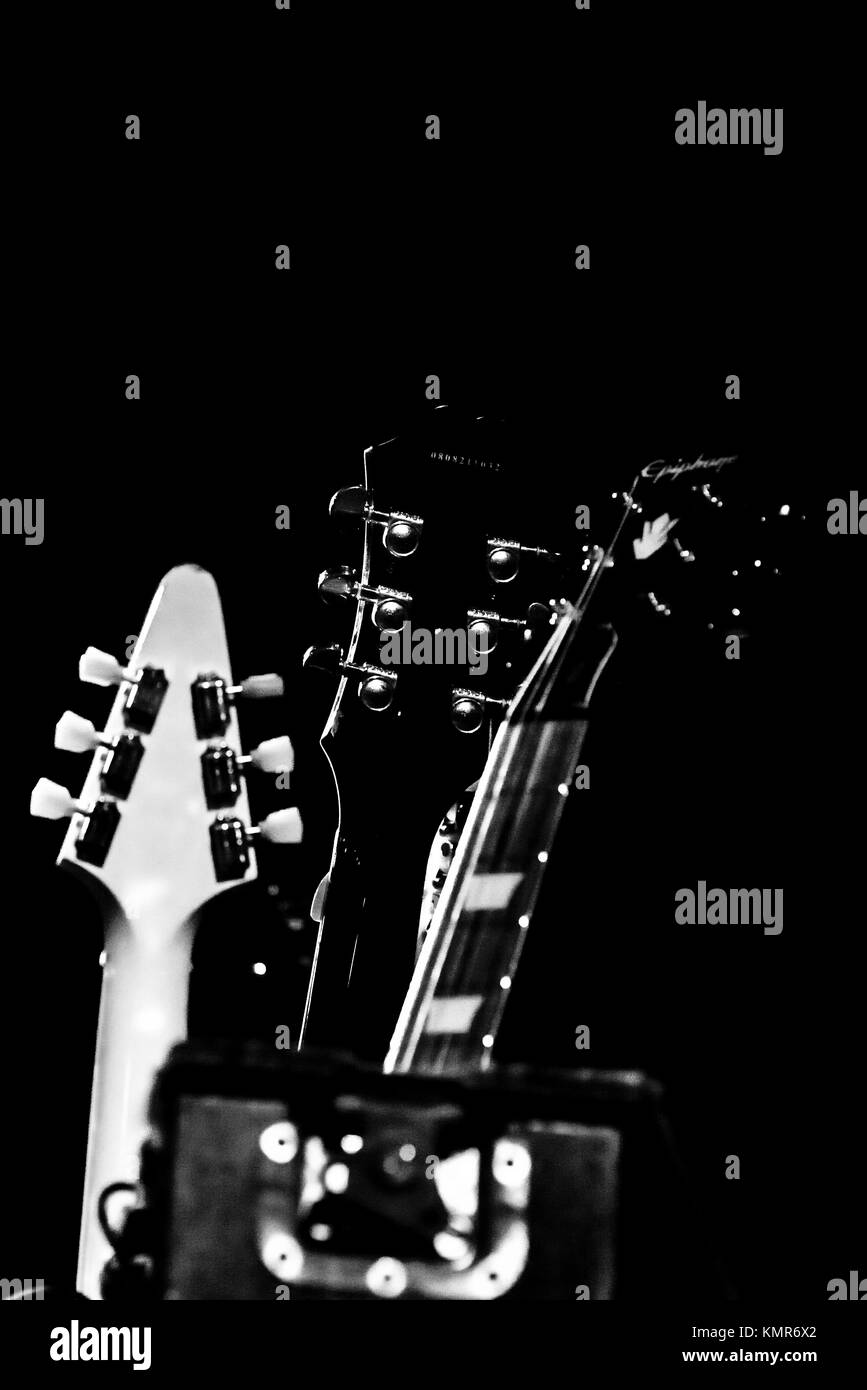 Black and white photo of close up of a set of guitar head stocks before