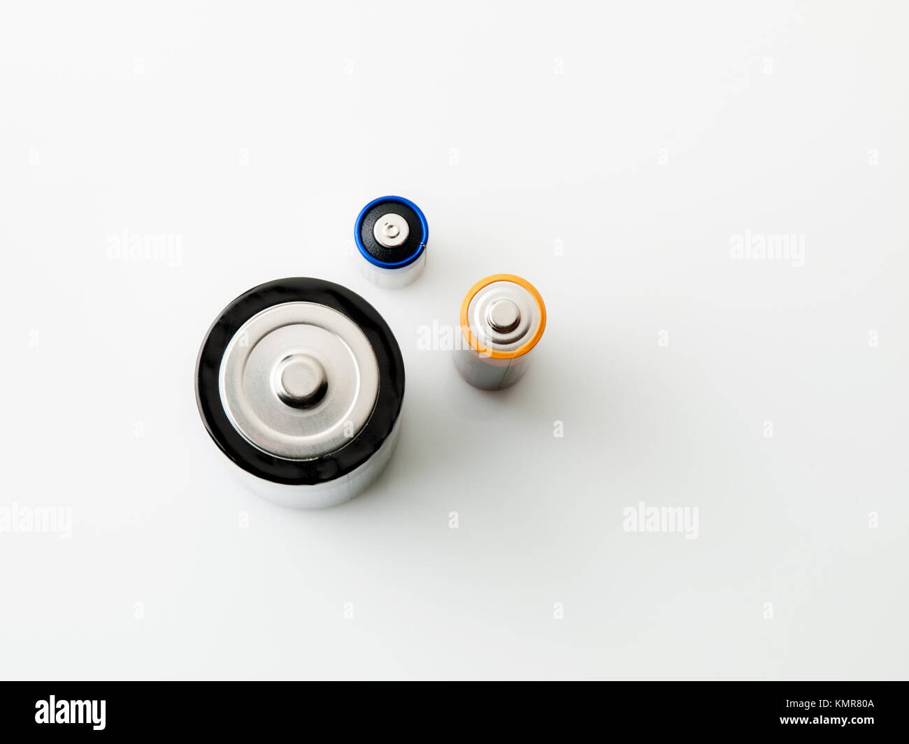 Close up detail of a group of three batteries (AA, D and 4LR44), isolated on white background Stock Photo