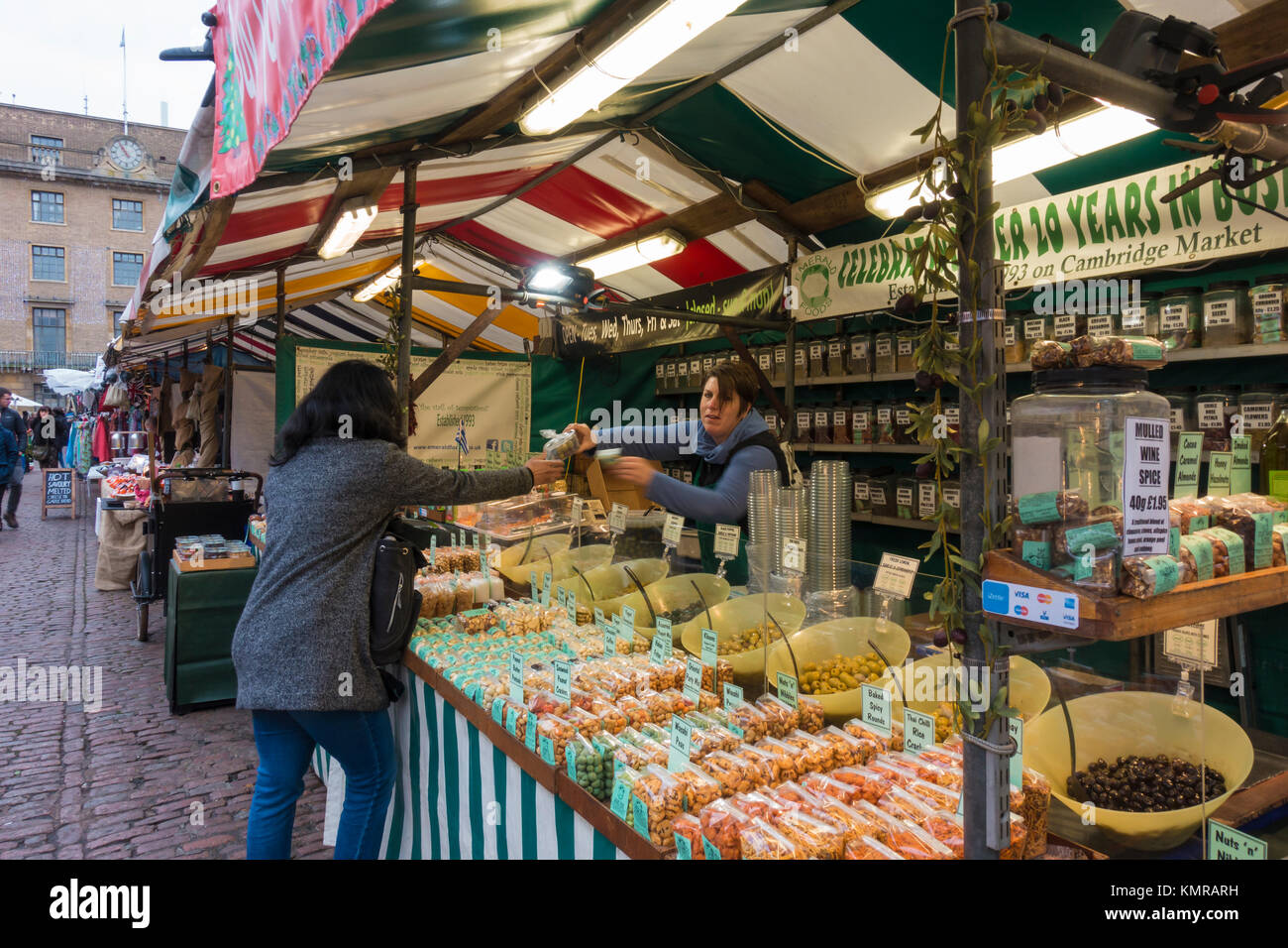 Customer being served by trader on herb and spice market stall Market Hill Cambridge Stock Photo