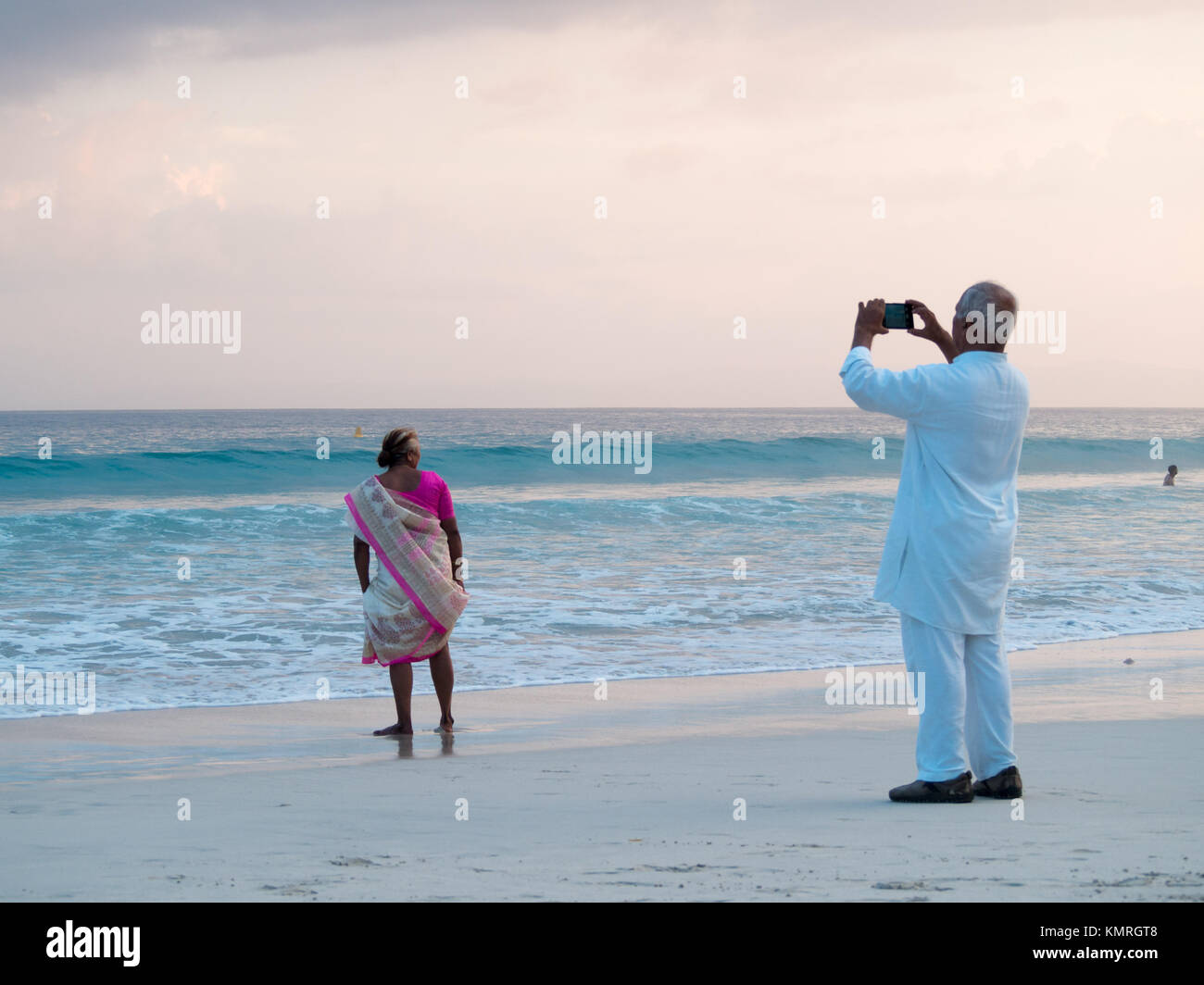 Old Indian couple taking a picture in Radhanagar beach, Havelock Stock Photo