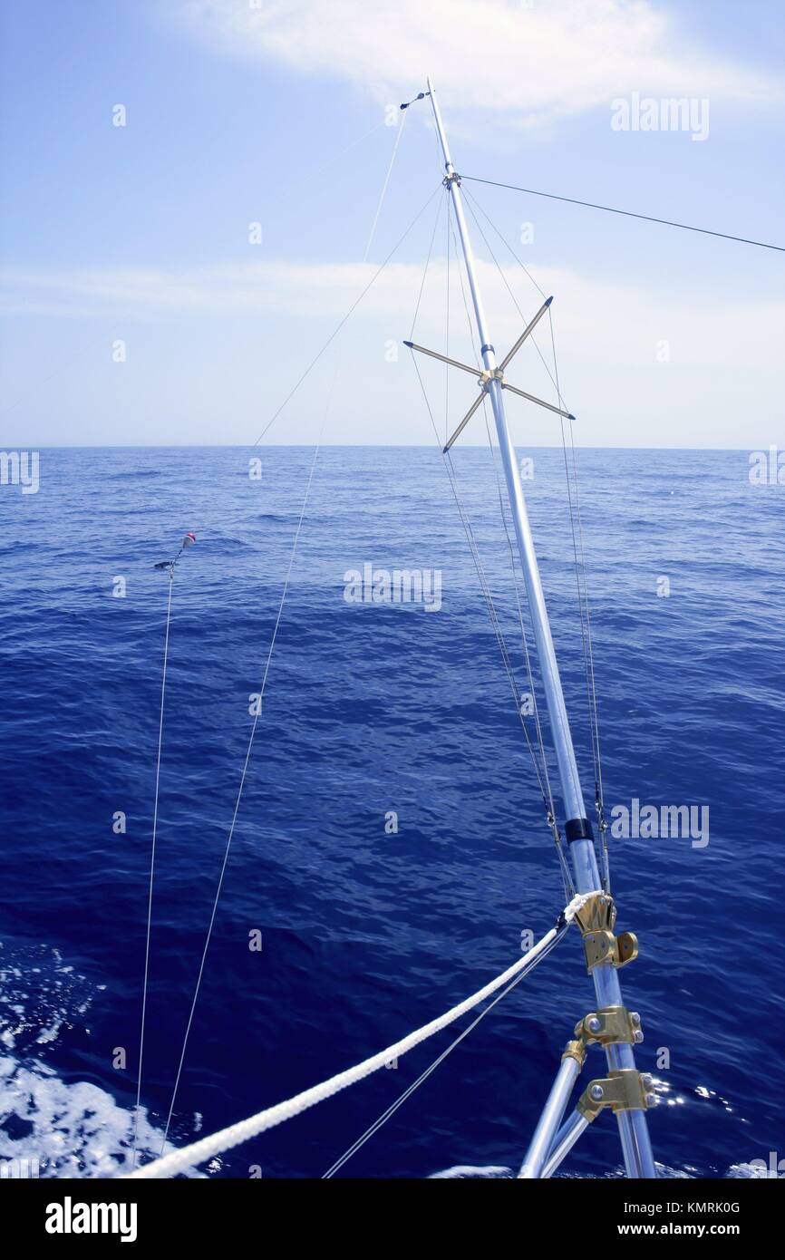 Blue sea with outrigger fishing boat equipment to spread wide the