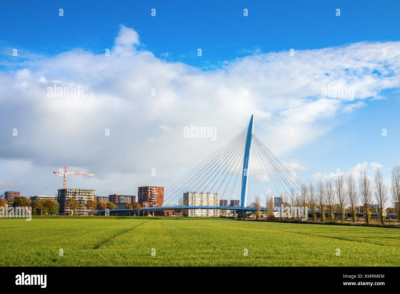Prince Claus Bridge under a blue sky with clouds. The Prince Claus Bridge is a cable-stayed bridge in Utrecht, The Netherlands. Stock Photo