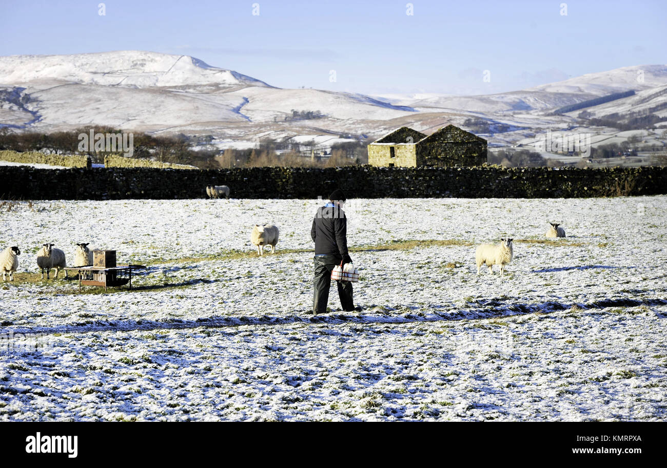 James Atkinson a milkman for Dales Dairies makes his deliveries in the Hawes area of the Yorkshire Dales, as parts of the UK and Ireland woke up to a blanket of snow caused by an Arctic airflow in the wake of Storm Caroline. Stock Photo