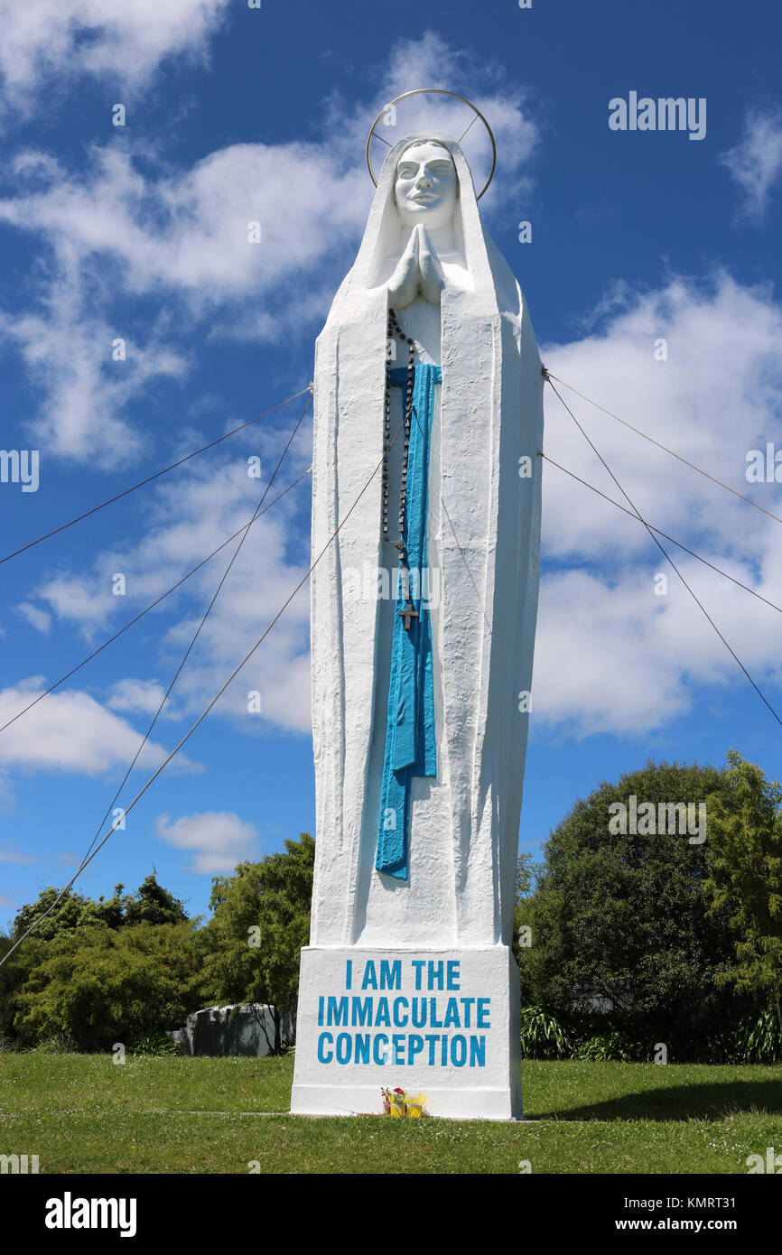 Our Lady of Lourdes statue of the Virgin Mary standing on a knoll above