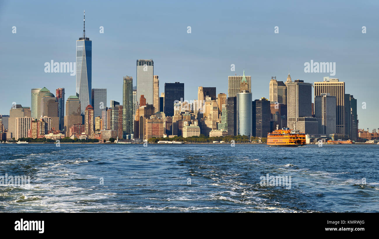 Panoramic view on the Financial District skyscrapers (One World Trade Center) with the Staten Island Ferry. Lower Manhattan, New York City Harbor Stock Photo
