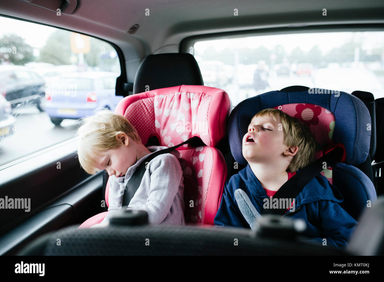 Tired brothers sleeping in car Stock Photo