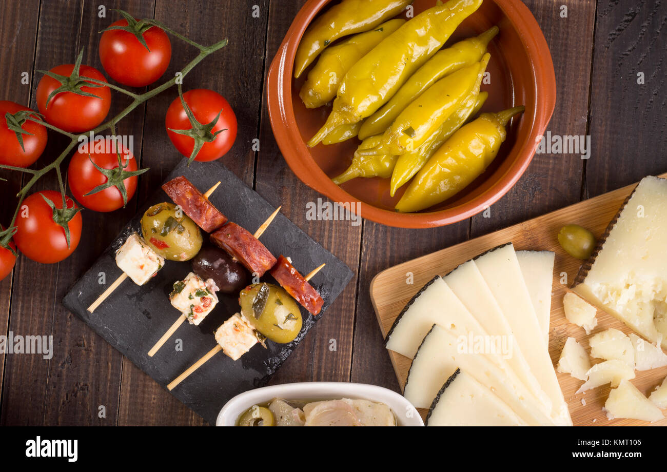 Sharing mixed spanish tapas starters on table. Top view Stock Photo