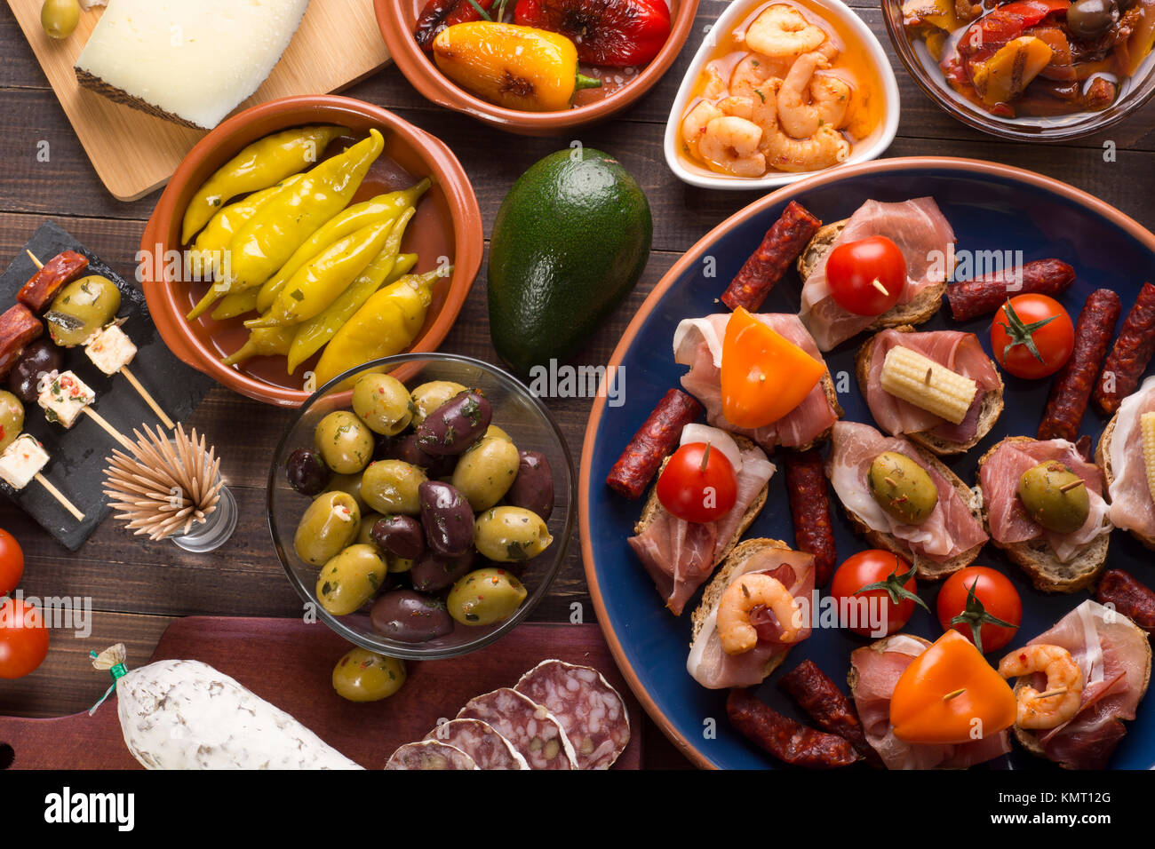 Sharing mixed spanish tapas starters on table. Top view Stock Photo