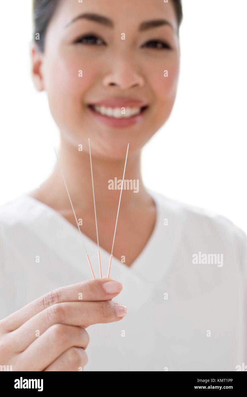 Woman holding acupuncture needles Stock Photo Alamy