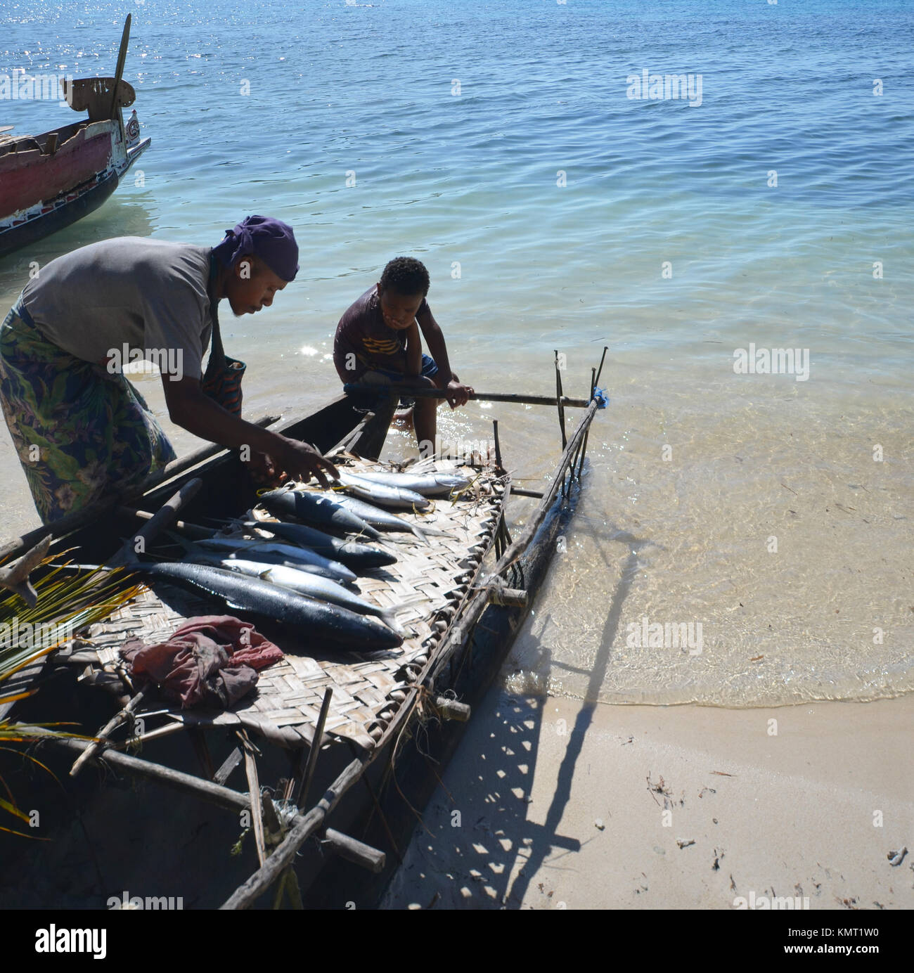Father and his sons with freshly caught fish on fishing boat Stock Photo