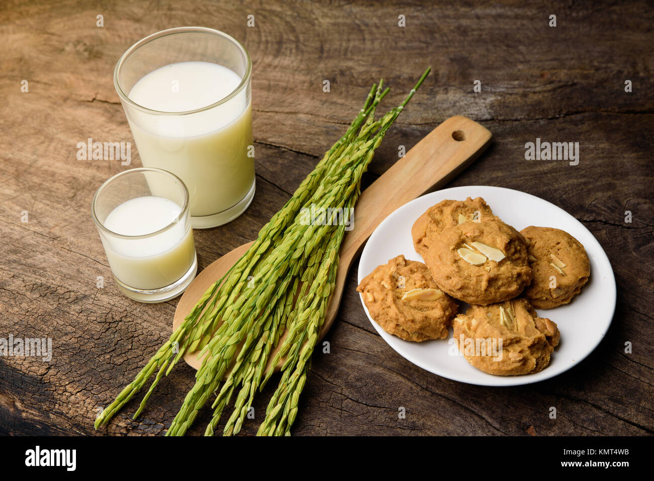 Almond Cookies with rice milk and ear of rice  on old wooden table for breakfast for vegetarian festival with warm light, background. Stock Photo