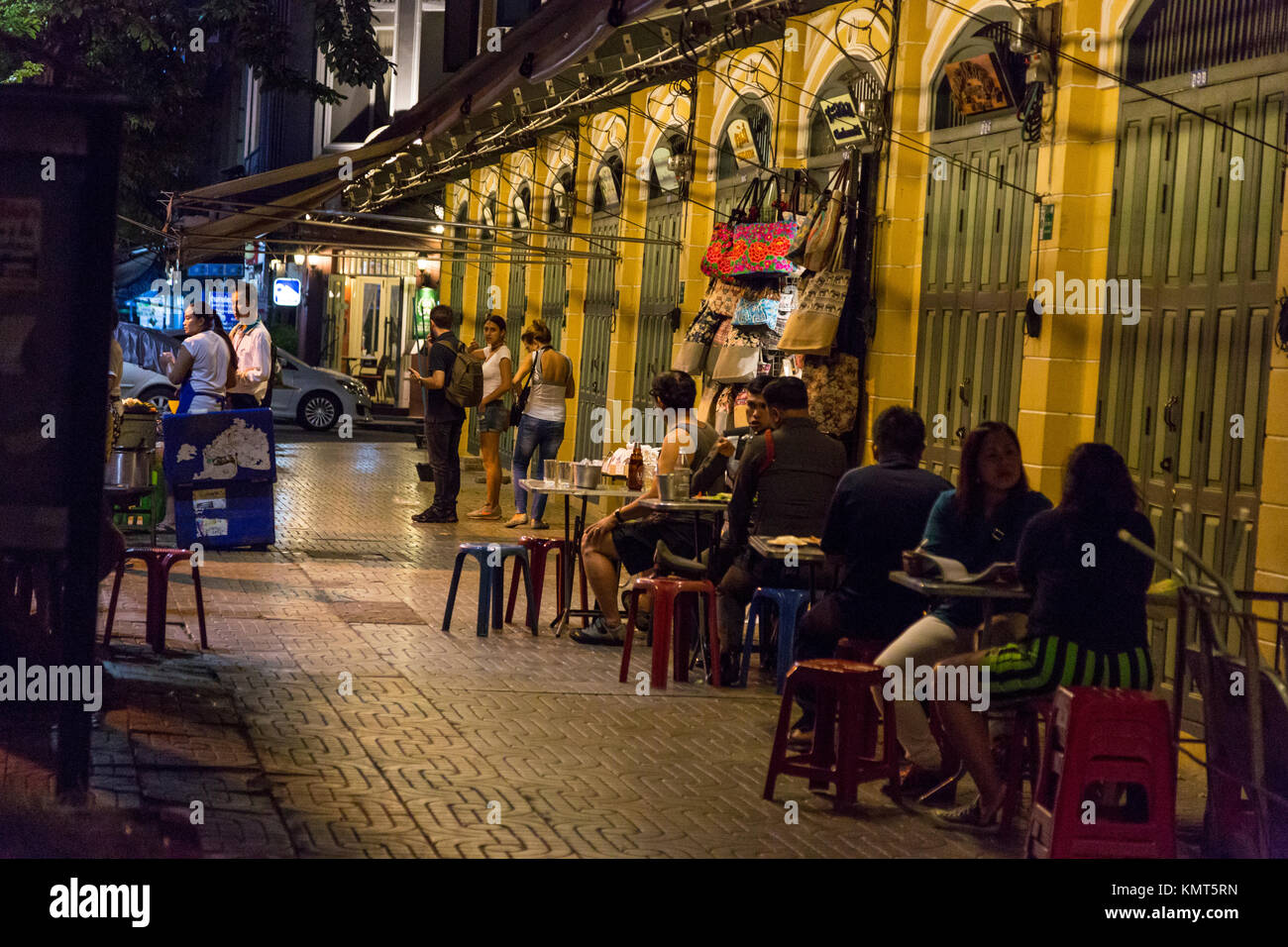 Bangkok, Thailand.  Late-night Diners in Sidewalk Restaurant Opposite Wat Pho Temple Compound. Stock Photo