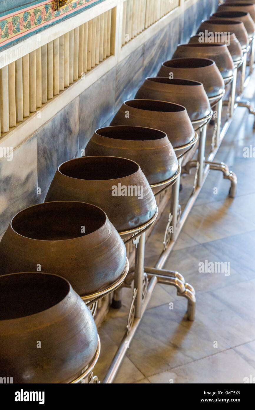 Bangkok, Thailand.  Wat Pho Temple.   Pots for Receiving Coins from Worshipers Seeking Blessings or Good Fortune. Stock Photo