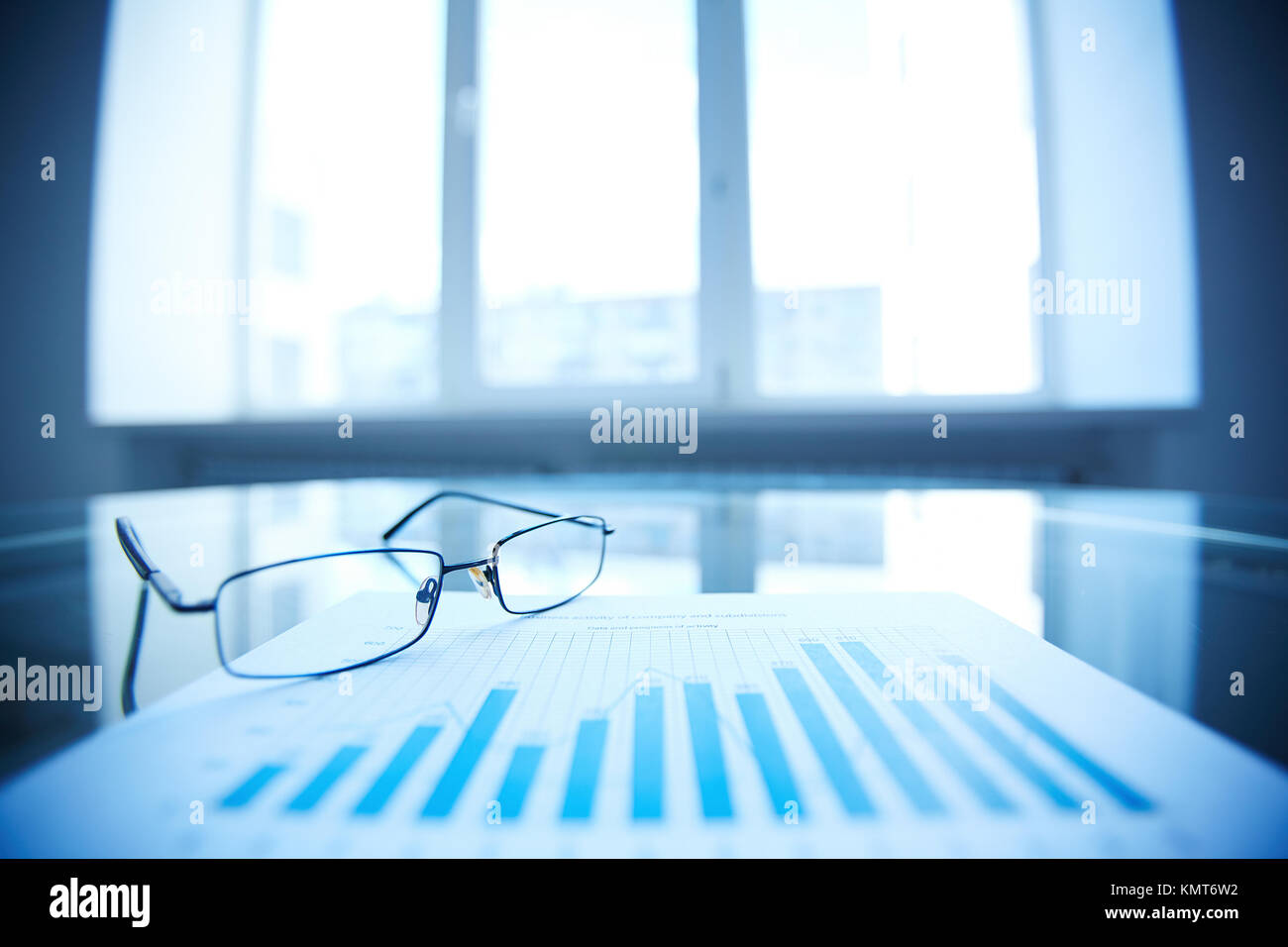 Image of eyeglasses and document on workplace Stock Photo