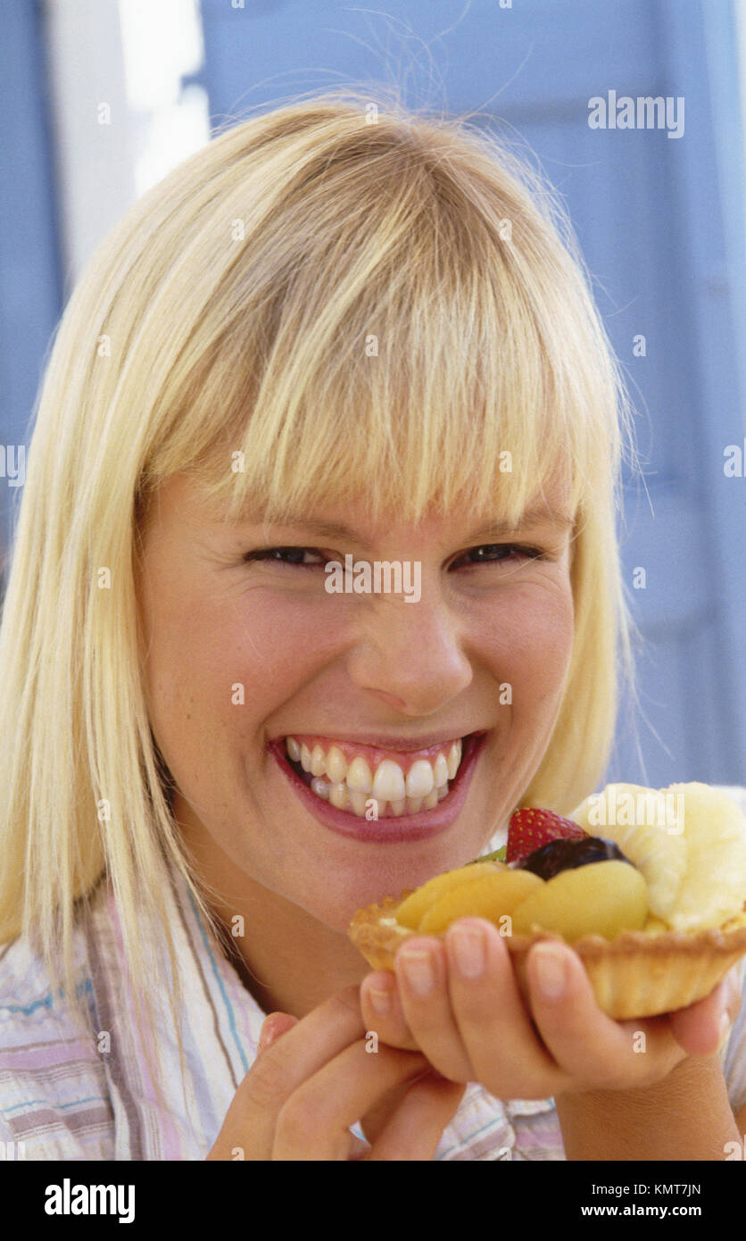 Woman eating a fruit cake Stock Photo Alamy
