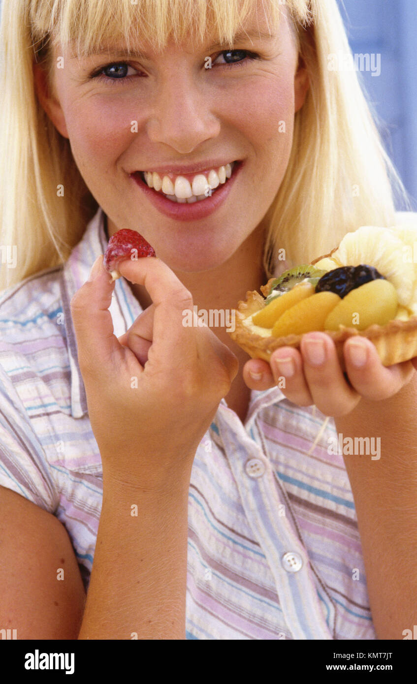 Woman eating a fruit cake Stock Photo Alamy