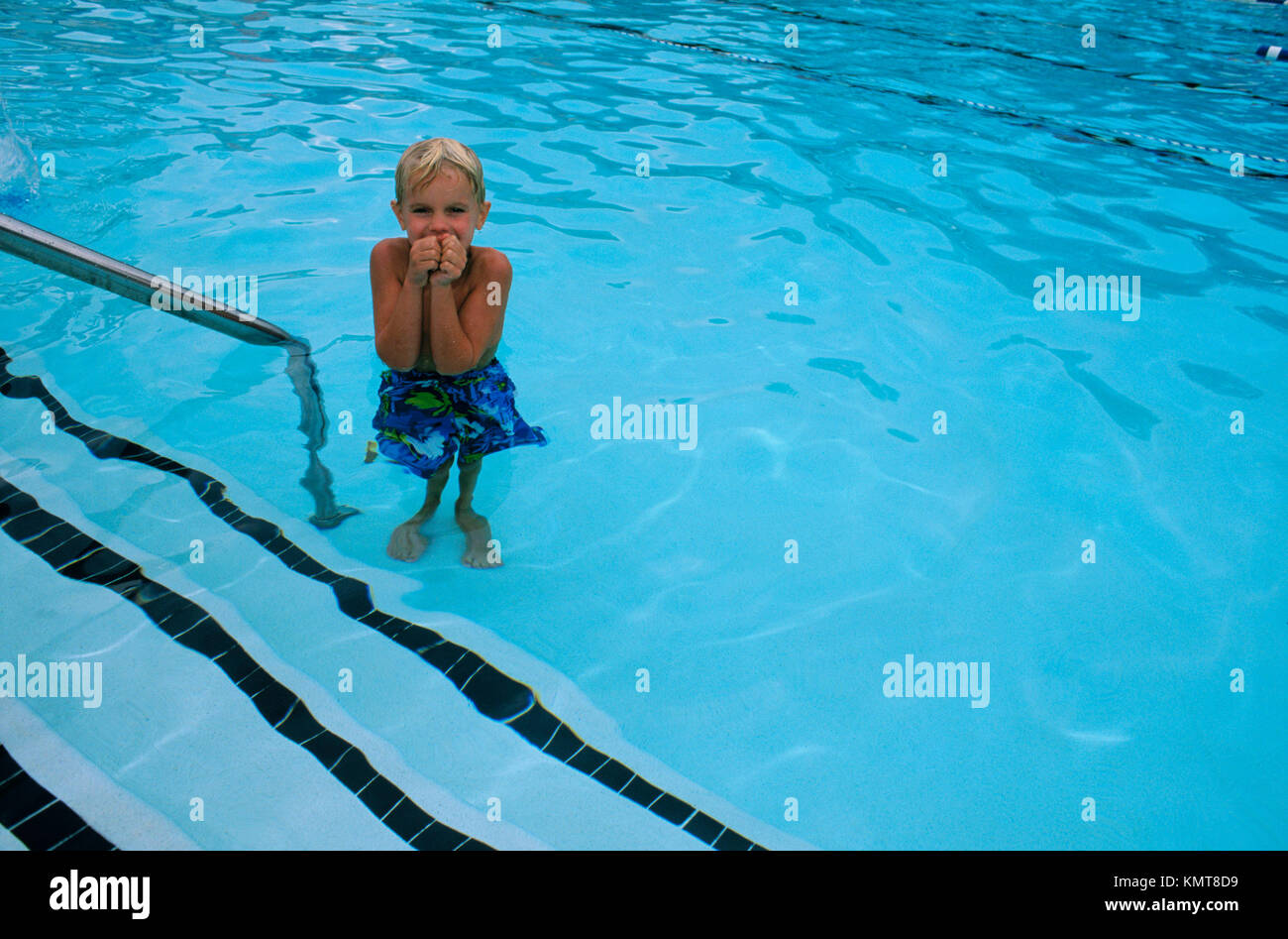 Boy shivering in swimming pool Stock Photo Alamy