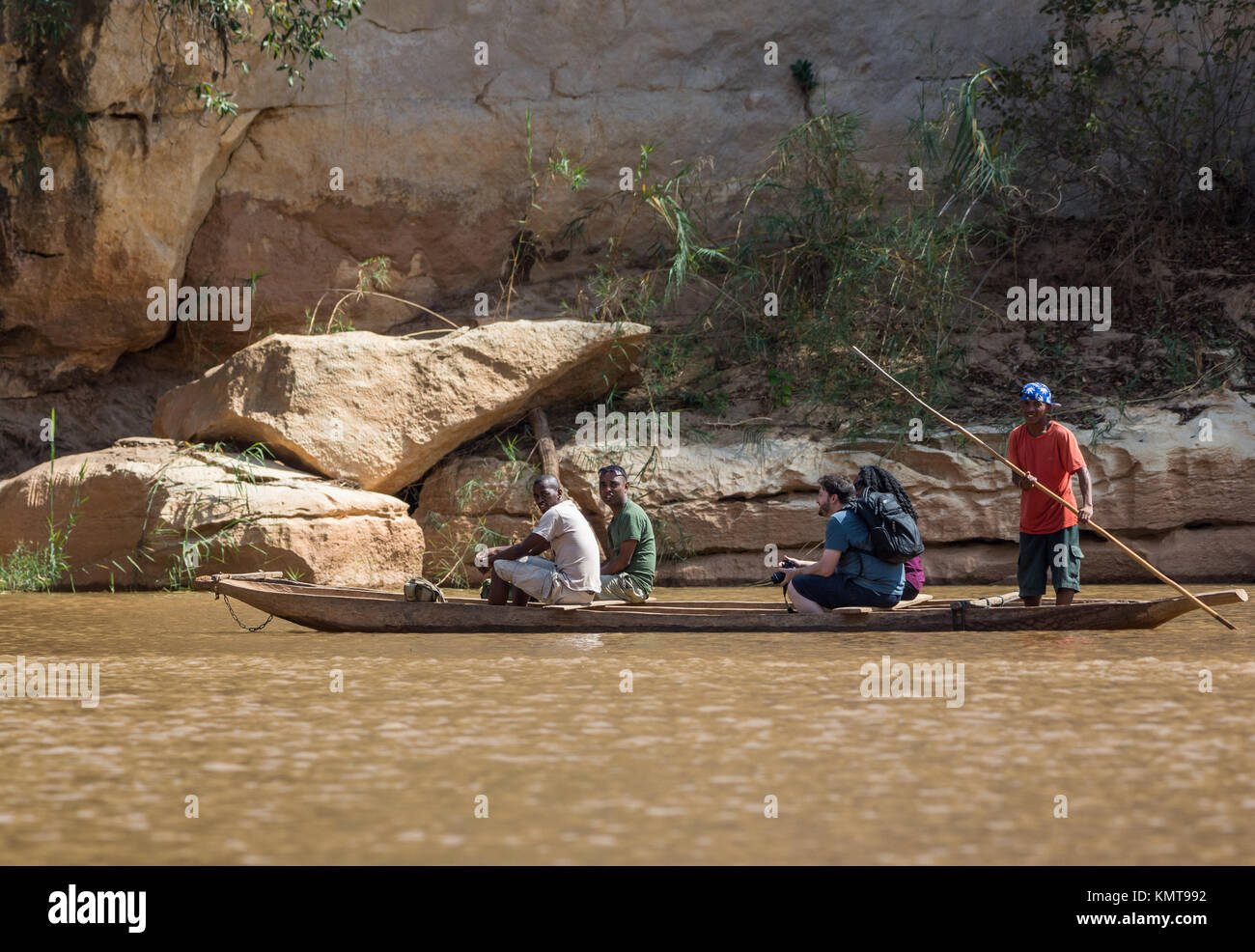 Local Malagasy guides take tourists for a dugout canoe ride on the river. Tsingy de Bemaraha National ParkMadagascar, Africa. Stock Photo