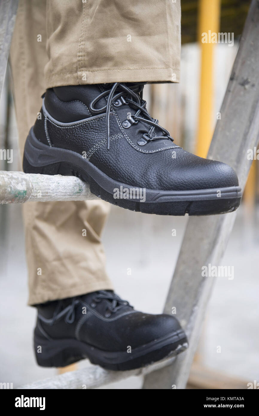 Construction worker with safety boots Stock Photo