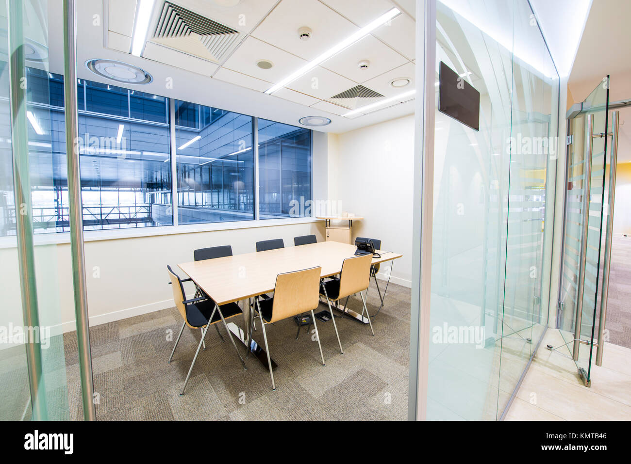 Empty small meeting room. Bright modern interior. Glass walls Stock Photo