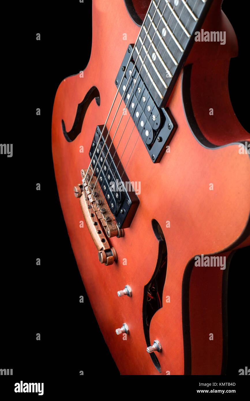 Hollow body electric guitar with humbuckers. Macro shot, black