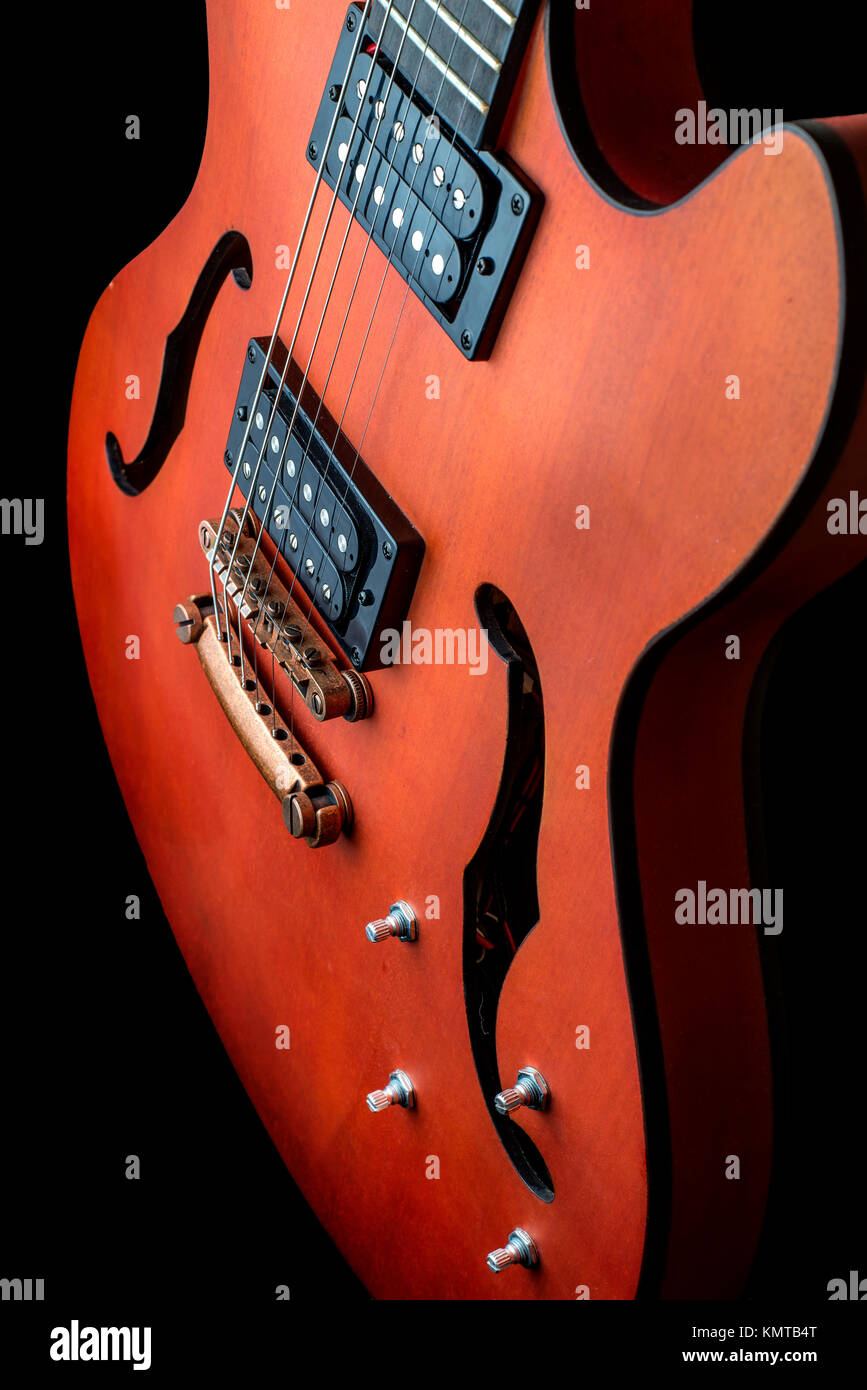 Hollow body electric guitar with humbuckers. Macro shot, black