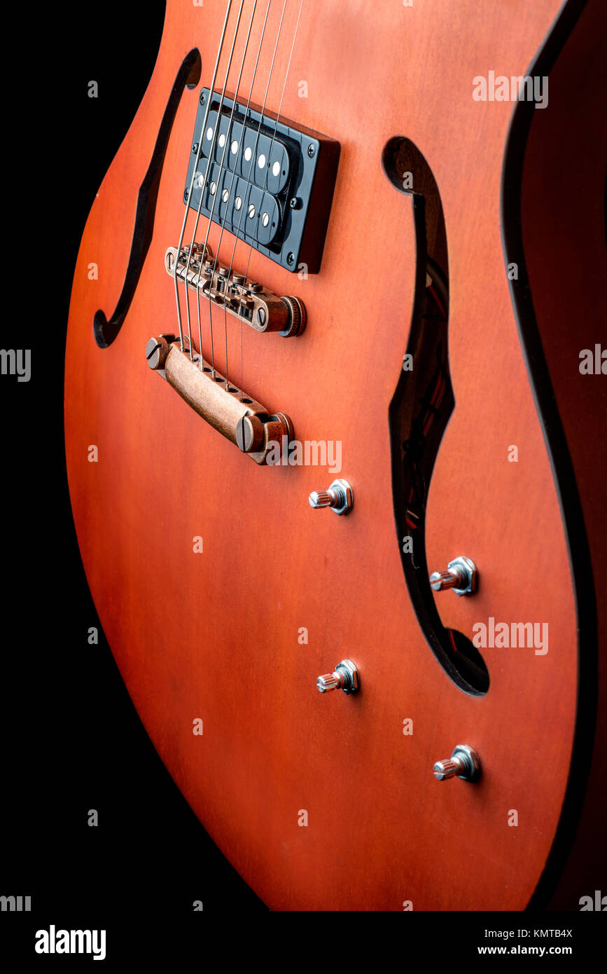 Hollow body electric guitar with humbuckers. Macro shot, black