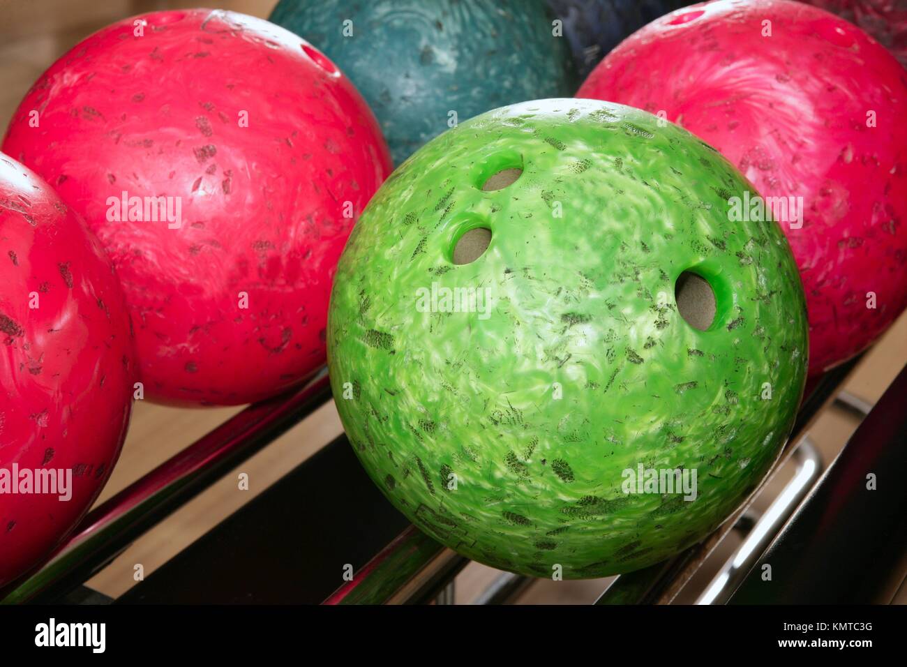 Bowling balls red green closeup row detail Stock Photo - Alamy