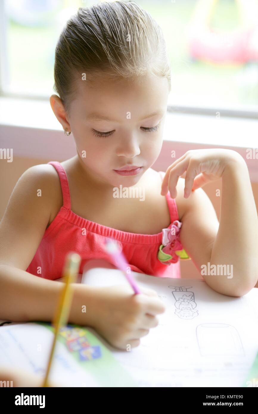 Little Toddler Girl Writing At School Desk Homework Stock Photo