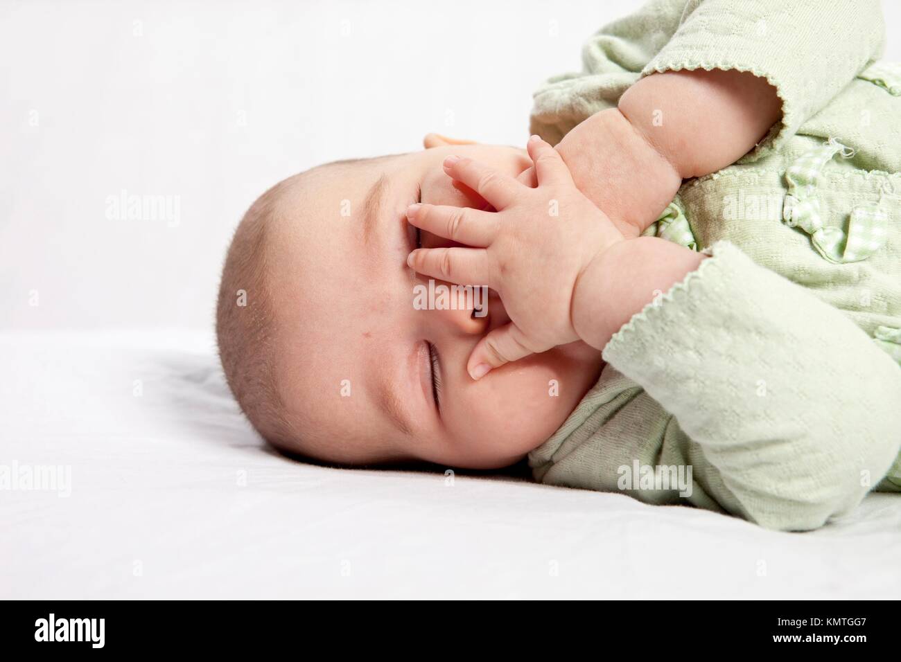 baby sleeping with hands over mouth, over white Stock Photo Alamy