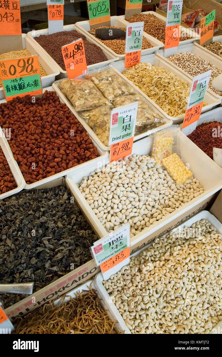 dried fish, nuts, fruit, seeds, and mushrooms displayed in bins on the