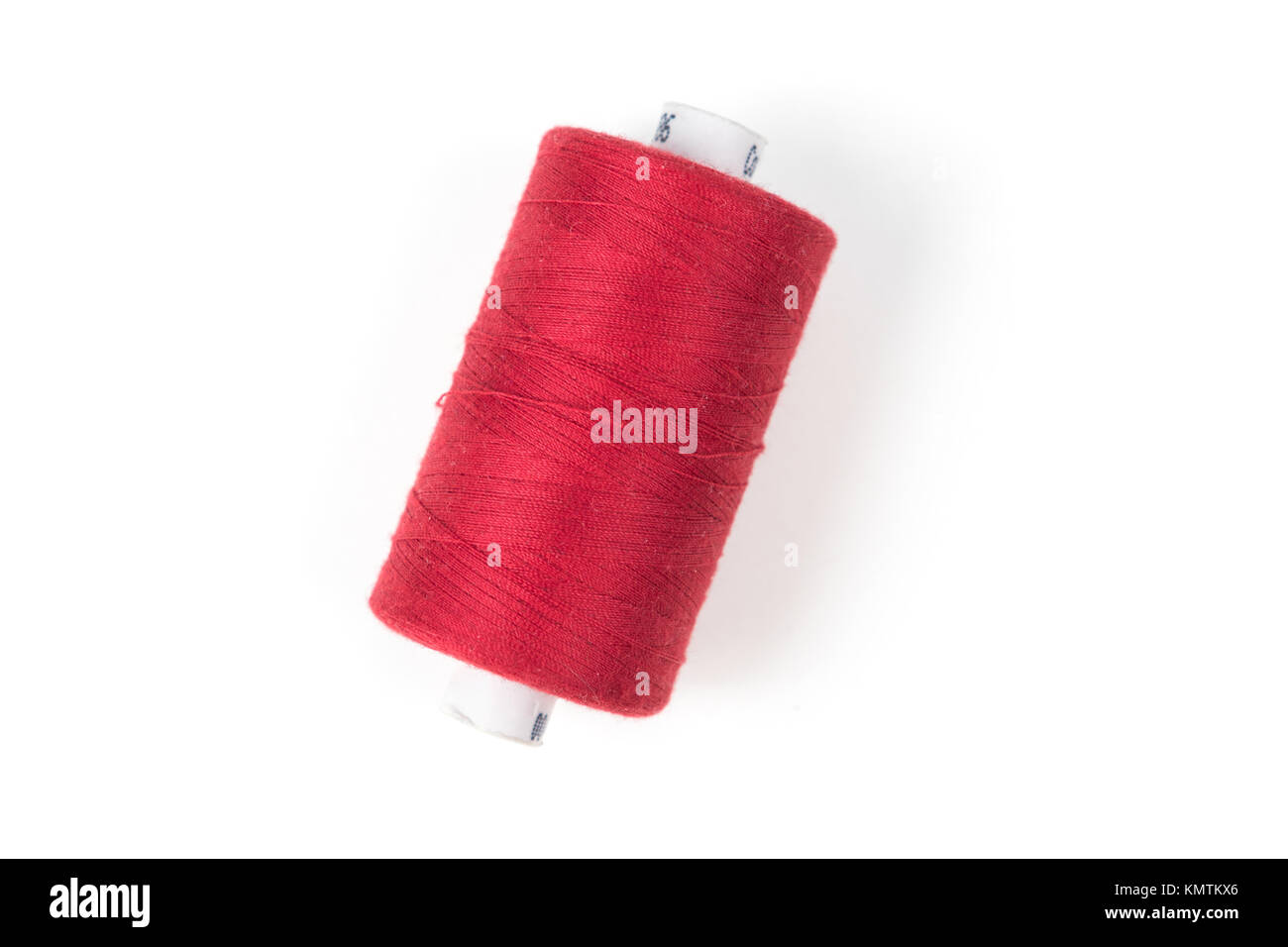 Red sewing thread on a white background Stock Photo Alamy