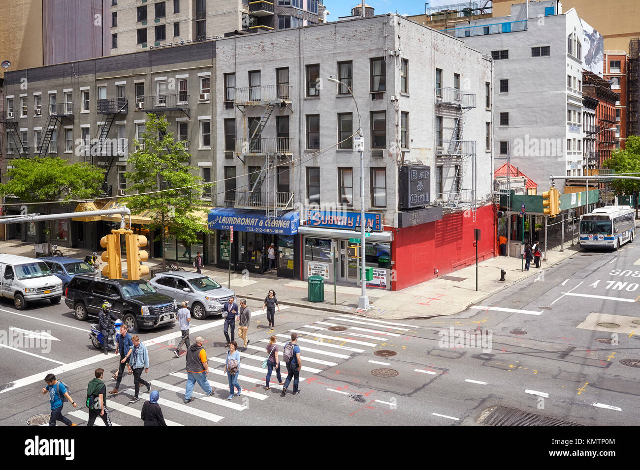 New York, USA - May 26, 2017: People cross the Second Avenue on the pedestrian crossing. Stock Photo