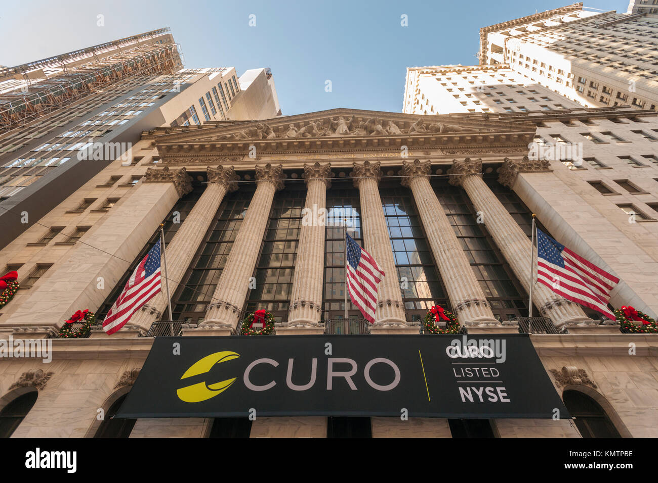 The New York Stock Exchange is decorated for the first day of trading for the Curo Group, seen on Thursday, December 7, 2017. The Curo Group, owner of the brands Speedy Cash and WageDayAdvance, provides payday loans to underbanked customers. Consumer advocates contend that payday loans are exploitive and force working poor clients into a spiral of ldebt.  (© Richard B. Levine) Stock Photo