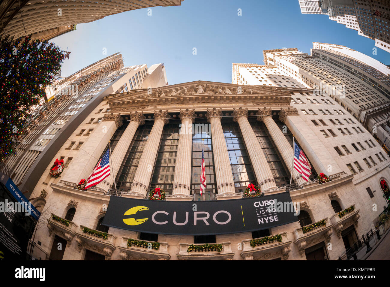 The New York Stock Exchange is decorated for the first day of trading for the Curo Group, seen on Thursday, December 7, 2017. The Curo Group, owner of the brands Speedy Cash and WageDayAdvance, provides payday loans to underbanked customers. Consumer advocates contend that payday loans are exploitive and force working poor clients into a spiral of ldebt.  (© Richard B. Levine) Stock Photo