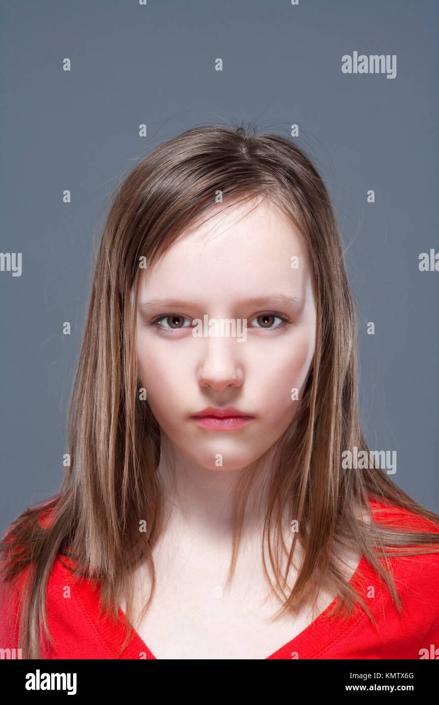 studio shot of an eleven years old girl posing as a fashion model Stock