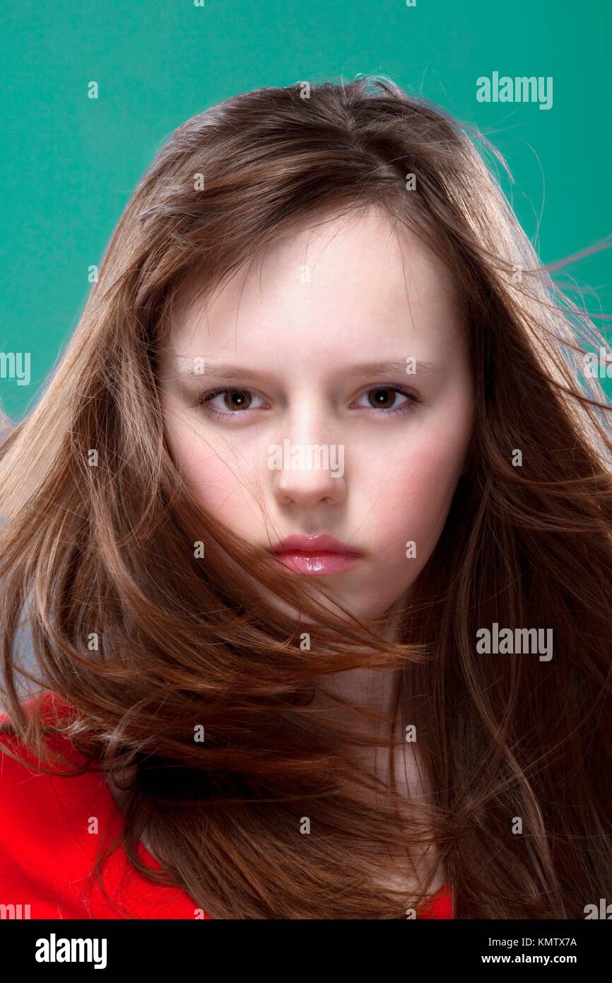 studio shot of an eleven years old girl posing as a fashion model Stock