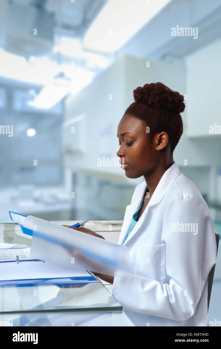 African-american biologist checks sequencing results in scientific lab or research facility. Focus on the face and eyelashes. Stock Photo
