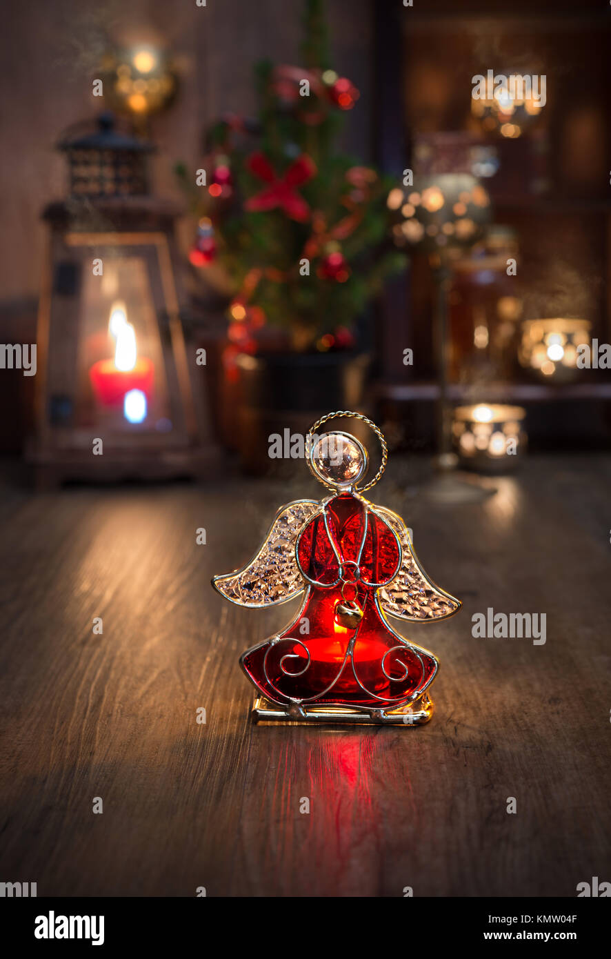 Christmas arrangement with candles and glass angel on vintage kitchen