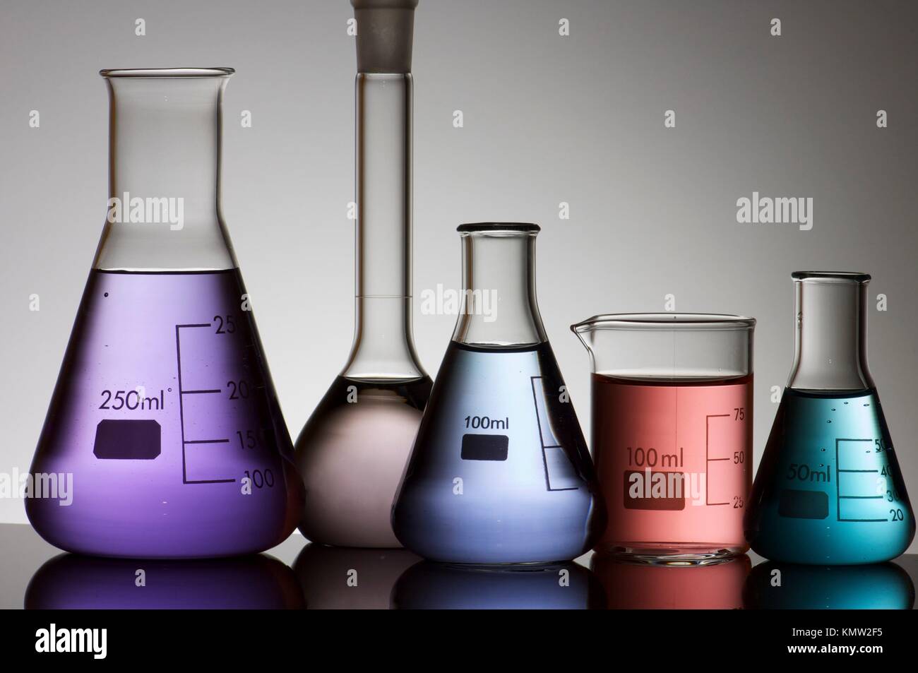 five laboratory flasks on a white backlight Stock Photo Alamy