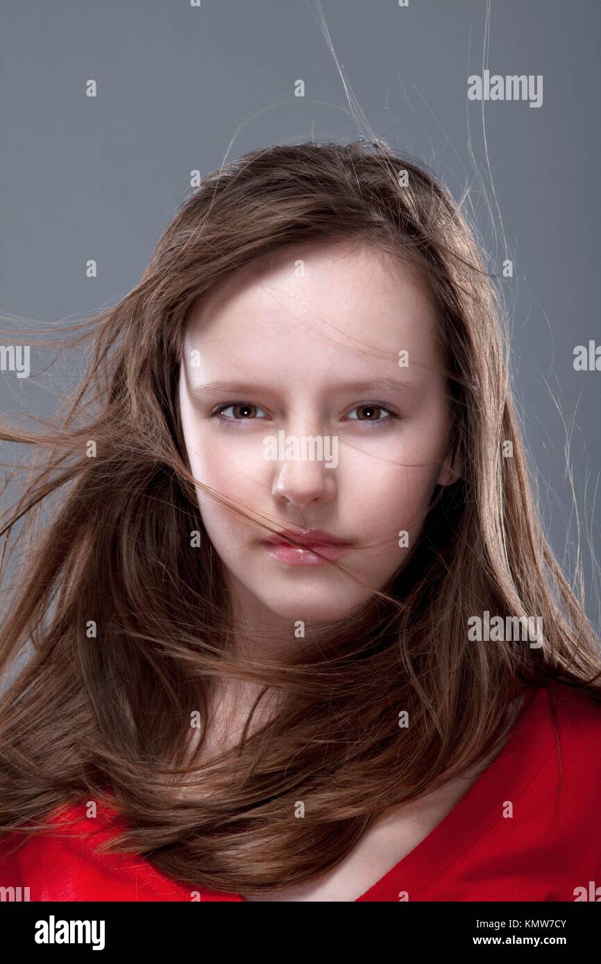 studio shot of an eleven years old girl posing as a fashion model Stock