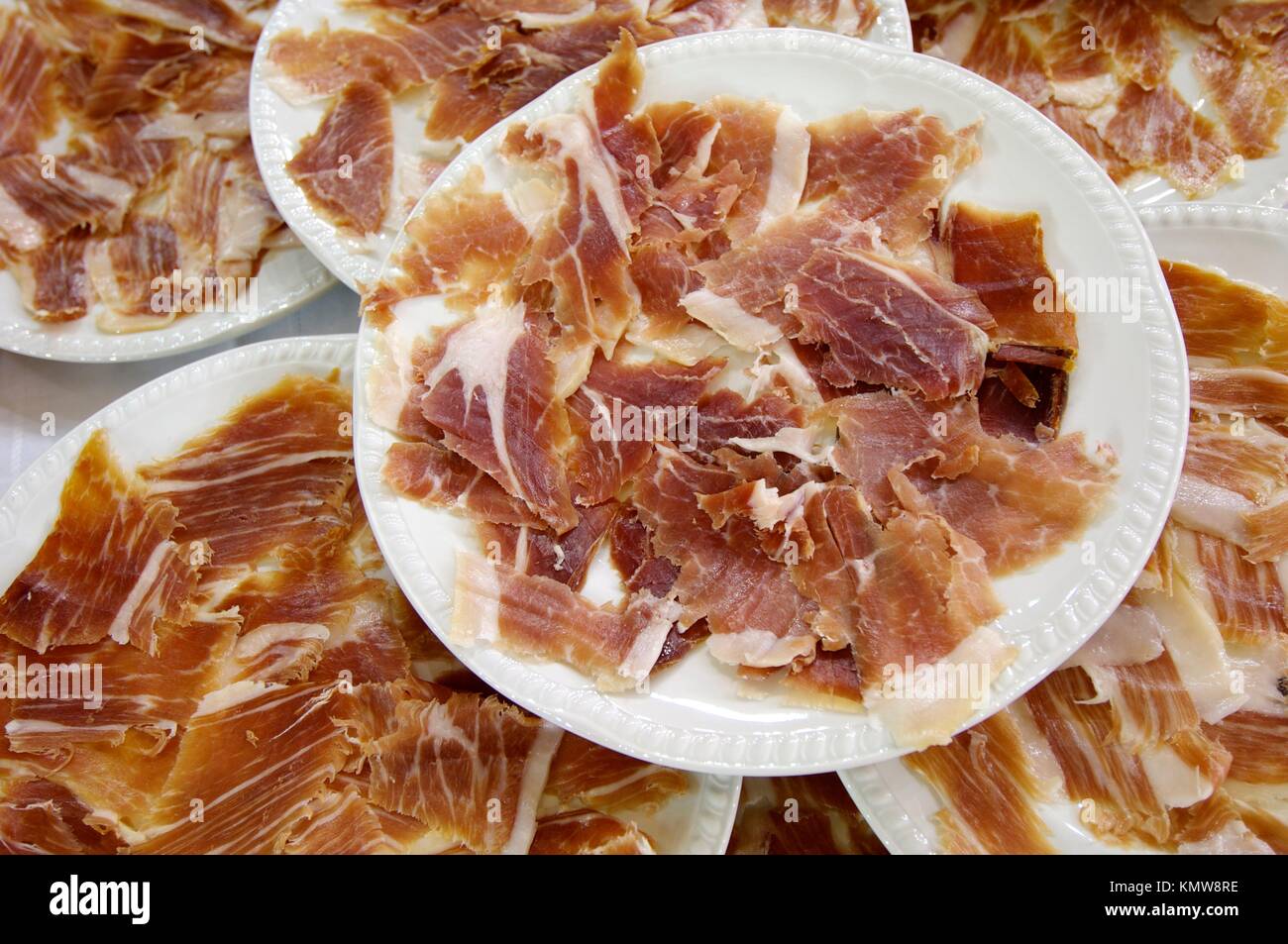 Typical Spanish ham sliced placed on white plates Stock Photo Alamy